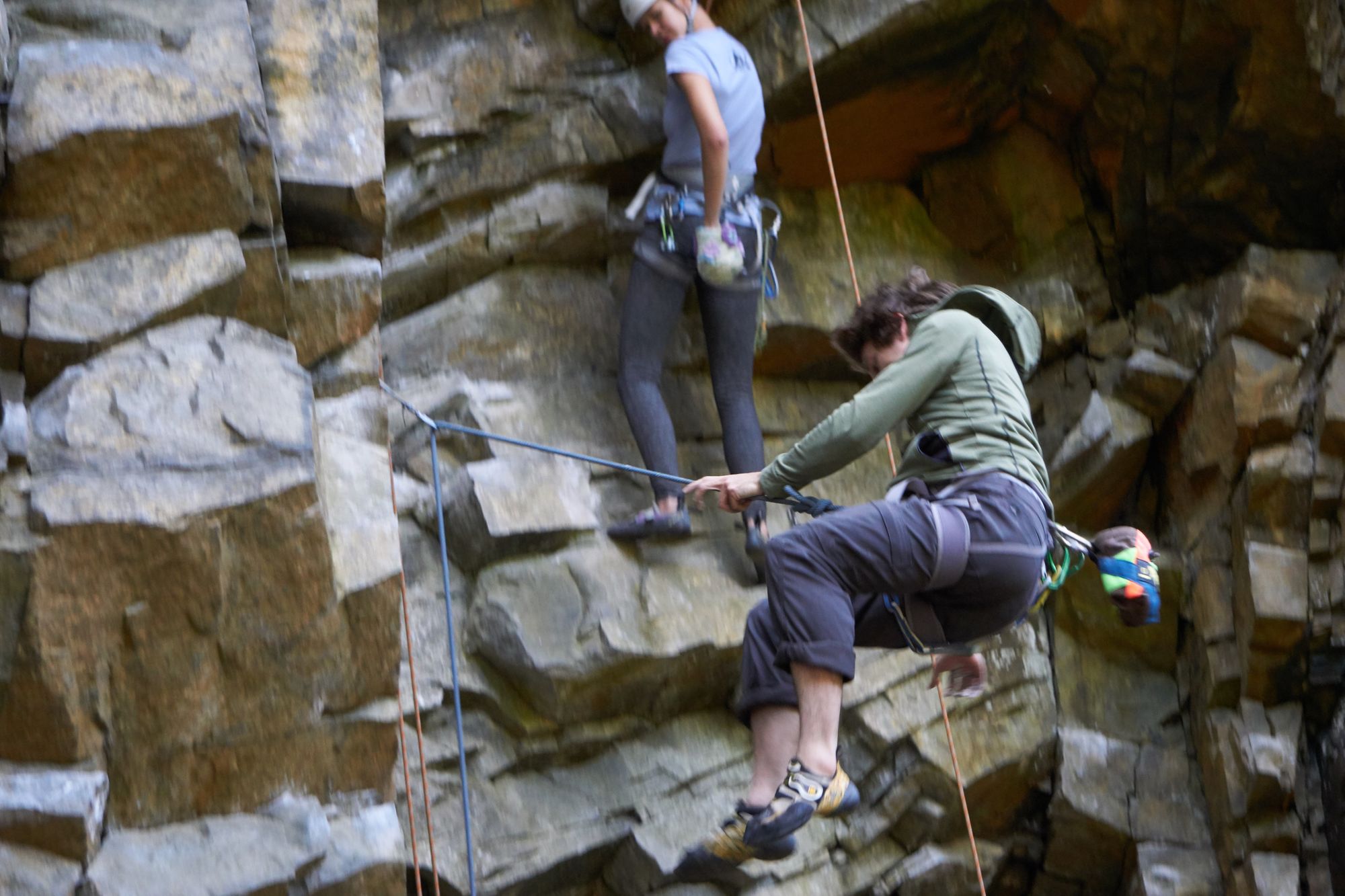 Man falling on his rope, with rebecca watching behind him.