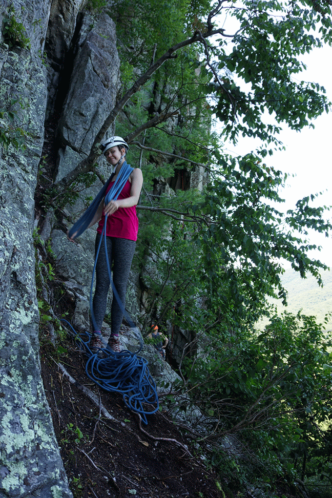 Animation of rebecca coiling a rope over her neck at the base of a climb.