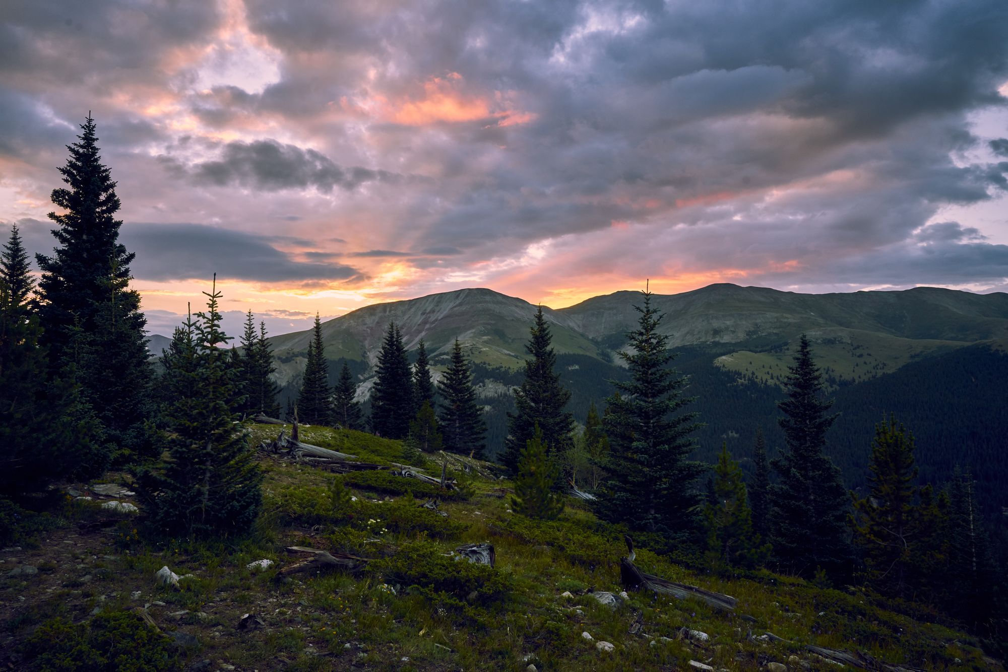 Sun rising over mountain terrain