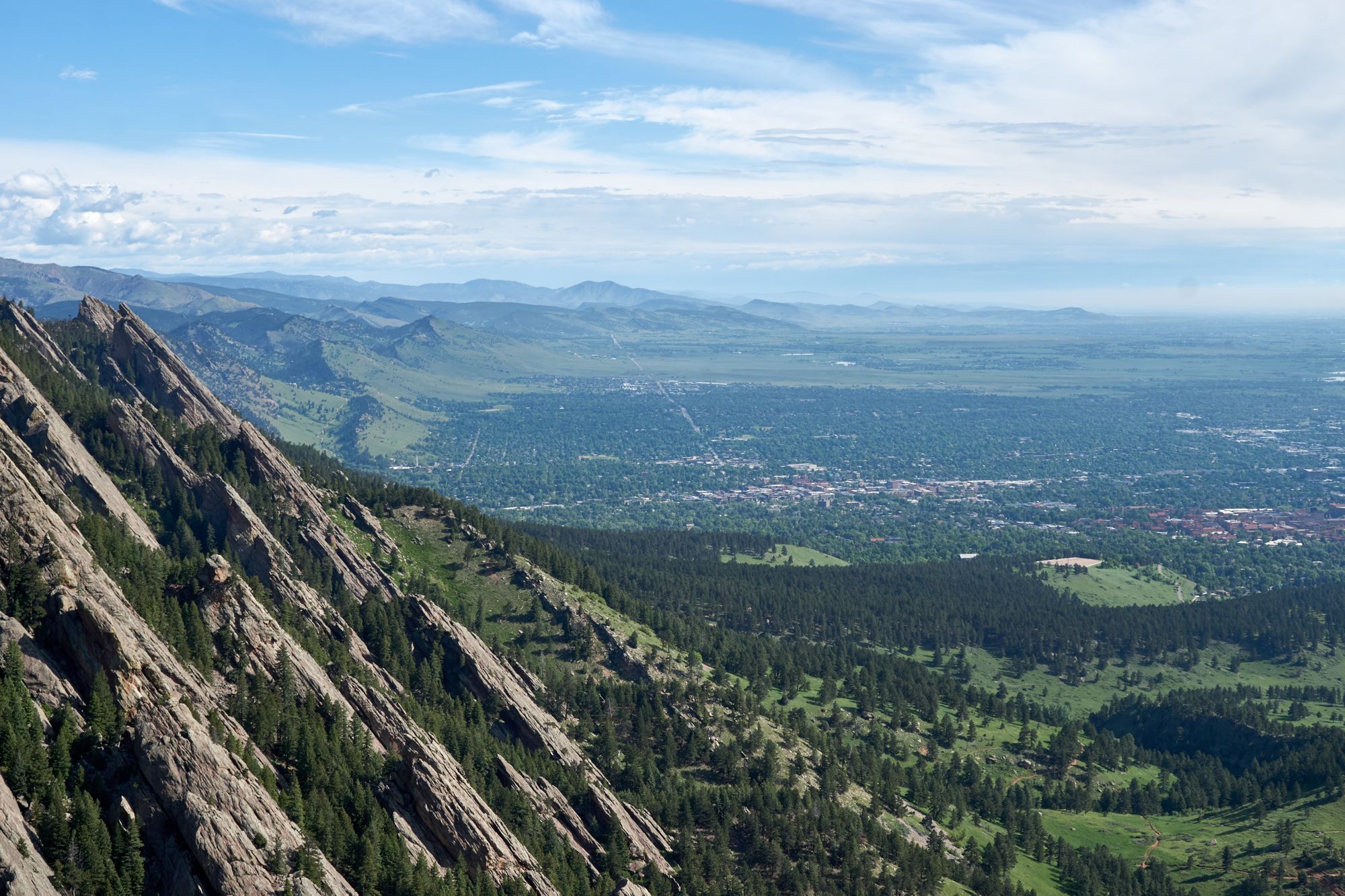 Landscape shot of boudler and the flatiron rocks to the left.